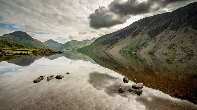 A view of the Wasdale hills reflected in the glassy waters at Wastwater, Lake District